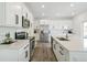 Modern kitchen with stainless steel appliances, a large island, quartz countertops, and white cabinets at 2520 Canfield Ln, Erie, CO 80026