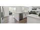 Modern kitchen with an island, stainless steel dishwasher, lots of natural light, and hardwood floors at 2520 Canfield Ln, Erie, CO 80026