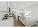 Beautiful kitchen with stainless steel appliances, a center island, white cabinets, and hardwood floors at 2520 Canfield Ln, Erie, CO 80026