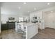 Open kitchen and living room concept with hardwood floors, white cabinets and lots of light at 2520 Canfield Ln, Erie, CO 80026