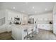 Spacious kitchen features a center island with seating, stainless steel appliances, and white cabinetry at 2520 Canfield Ln, Erie, CO 80026
