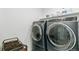Modern laundry area with front-loading washer and dryer at 2520 Canfield Ln, Erie, CO 80026