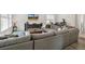 Open living room showcasing a large sectional sofa, media console, and bright natural light at 2520 Canfield Ln, Erie, CO 80026