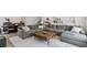 Spacious living room with a large sectional sofa, perfect for relaxing and entertaining in a comfortable setting at 2520 Canfield Ln, Erie, CO 80026