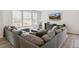 Comfortable living room featuring a sectional sofa, media center, and large windows, ideal for relaxing and entertainment at 2520 Canfield Ln, Erie, CO 80026