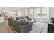 Bright and airy living space featuring a large sectional sofa, modern decor, and seamless connection to the kitchen at 2520 Canfield Ln, Erie, CO 80026