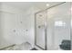 Modern walk-in shower with a glass door, tiled walls, and a built-in shelf at 2520 Canfield Ln, Erie, CO 80026