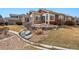 Well-maintained backyard with rock garden, small water feature, and lush grass at 13756 Legend Trl # 101, Broomfield, CO 80023