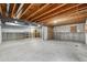 Unfinished basement with concrete floor, exposed beams, and painted drywall at 13756 Legend Trl # 101, Broomfield, CO 80023