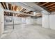 Unfinished basement area with concrete floor, painted walls and exposed ceiling at 13756 Legend Trl # 101, Broomfield, CO 80023