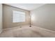 Bright, carpeted bedroom with neutral walls, and a window with white blinds at 13756 Legend Trl # 101, Broomfield, CO 80023