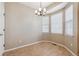 Bright dining area featuring tile flooring, modern chandelier, and natural light from the windows at 13756 Legend Trl # 101, Broomfield, CO 80023