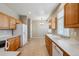 Cozy kitchen featuring wooden cabinetry and tile floors with ample counter space for easy food preparation at 13756 Legend Trl # 101, Broomfield, CO 80023