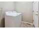 Practical laundry room with standard-size white washer and dryer and tile floor at 13756 Legend Trl # 101, Broomfield, CO 80023