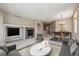 Comfortable living room with a stone fireplace leading into dining area with modern furnishings and decor at 13756 Legend Trl # 101, Broomfield, CO 80023