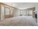 Expansive living room filled with natural light featuring neutral carpet, and a charming stone fireplace at 13756 Legend Trl # 101, Broomfield, CO 80023