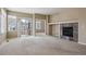 Bright living room with a stone fireplace and sliding door access to an outdoor patio or balcony at 13756 Legend Trl # 101, Broomfield, CO 80023