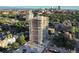 High-rise condominium building surrounded by mature trees and lush landscaping, offering stunning city and mountain views at 130 N Pearl St # 1606, Denver, CO 80203