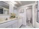 Charming bathroom featuring marble floors, a double sink vanity, and modern light fixtures at 130 N Pearl St # 1606, Denver, CO 80203