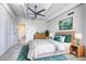 Bright bedroom featuring a ceiling fan and en-suite bathroom, accented with a plush rug and stylish decor at 130 N Pearl St # 1606, Denver, CO 80203