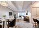 Open concept living room with a modern design, white walls, light floors, and a balcony offering beautiful views at 130 N Pearl St # 1606, Denver, CO 80203
