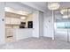Bright living space with a modern chandelier, adjacent to a sleek kitchen and featuring city skyline views at 130 N Pearl St # 1606, Denver, CO 80203