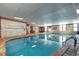 Spacious indoor pool area with lounge chairs, tables, and bright lighting at 130 N Pearl St # 1606, Denver, CO 80203