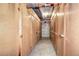 Storage units line a hallway with concrete floors and visible pipes along the ceiling at 130 N Pearl St # 1606, Denver, CO 80203