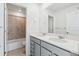 Bathroom with double sink vanity, large mirror, and tiled shower/tub combo at 4273 Ridgewalk Pt, Castle Rock, CO 80108