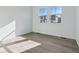 Bright bedroom with light-colored walls, luxury vinyl plank flooring, and large windows with neighborhood views at 4273 Ridgewalk Pt, Castle Rock, CO 80108