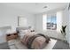 Comfortable bedroom with soft gray tones, a plush bed, and ample natural light at 4273 Ridgewalk Pt, Castle Rock, CO 80108