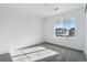 Cozy bedroom with neutral carpet and a large window offering natural light at 4273 Ridgewalk Pt, Castle Rock, CO 80108