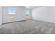 Upstairs bedroom featuring neutral carpet and two windows with neighborhood views at 4273 Ridgewalk Pt, Castle Rock, CO 80108