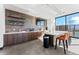 Chic coffee bar featuring wooden cabinets, floating shelves, and a sleek counter, ideal for morning refreshments at 4273 Ridgewalk Pt, Castle Rock, CO 80108
