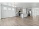 Spacious kitchen with gray cabinets, stainless appliances, and island, open to the dining and entry areas at 4273 Ridgewalk Pt, Castle Rock, CO 80108