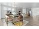 Bright, neutral-toned kitchen and dining area in an open floor plan, featuring stainless appliances and island seating at 4273 Ridgewalk Pt, Castle Rock, CO 80108