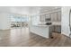 Open-concept kitchen with gray cabinets, a spacious island, and scenic views from large windows at 4273 Ridgewalk Pt, Castle Rock, CO 80108