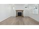 Bright living room with a fireplace, light-colored walls, luxury vinyl plank flooring, and ample windows at 4273 Ridgewalk Pt, Castle Rock, CO 80108