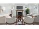 Cozy living room features a fireplace, comfortable seating, and ample natural light at 4273 Ridgewalk Pt, Castle Rock, CO 80108
