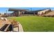 Community park featuring manicured artificial turf, grilling area and picnic tables under a trellis at 4273 Ridgewalk Pt, Castle Rock, CO 80108