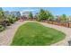 A backyard featuring a green grass area surrounded by rocks and a wooden fence at 7312 Grady Cir, Castle Rock, CO 80108