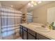 Bathroom featuring double sinks and a shower with striped curtain at 7312 Grady Cir, Castle Rock, CO 80108