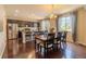 Bright dining room with hardwood floors, large windows and stylish chandelier at 7312 Grady Cir, Castle Rock, CO 80108