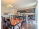 Bright dining room with wood floors, open to kitchen, and stylish light fixture at 7312 Grady Cir, Castle Rock, CO 80108