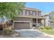 Attractive two-story home with a covered front porch, complemented by mature landscaping and a two-car garage at 7312 Grady Cir, Castle Rock, CO 80108