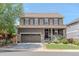 Two story home with a two car garage, covered porch, stone accents, and irrigation system at 7312 Grady Cir, Castle Rock, CO 80108