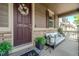 Inviting covered porch with seating, a welcoming wreath, and stylish decor at 7312 Grady Cir, Castle Rock, CO 80108