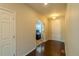 Hallway leading to an office, with dark wood floors and neutral paint at 7312 Grady Cir, Castle Rock, CO 80108