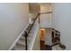 Hallway with carpeted stairs and wood railing, leading to upper and lower levels at 7312 Grady Cir, Castle Rock, CO 80108