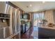 Well-equipped kitchen with stainless steel refrigerator, dark wood cabinets, and sliding glass door to backyard at 7312 Grady Cir, Castle Rock, CO 80108